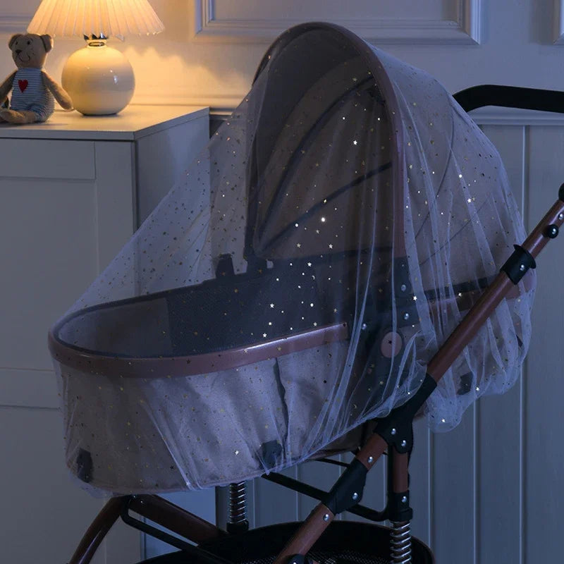Baby stroller with a star-patterned canopy in a room setting.