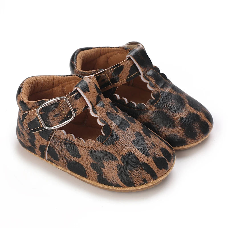 Leopard print baby shoes with a buckle on a white background