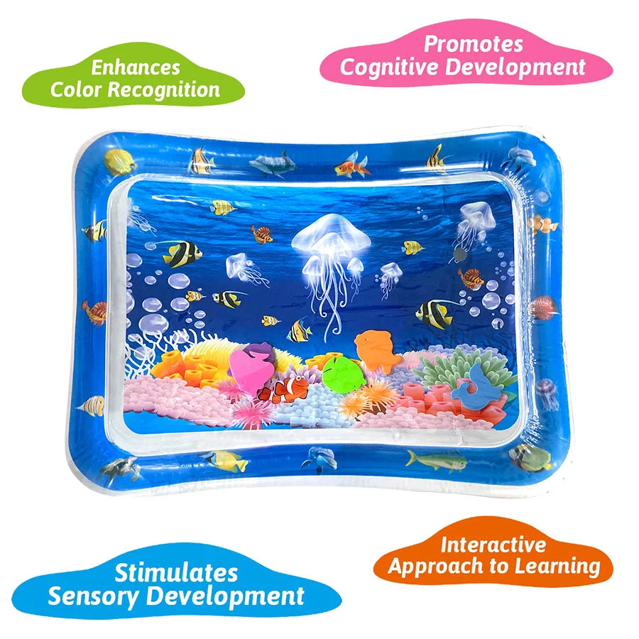 Inflatable baby water sensory play mat with blue ocean scene, colorful fish, jellyfish, coral, and floating sensory pieces.