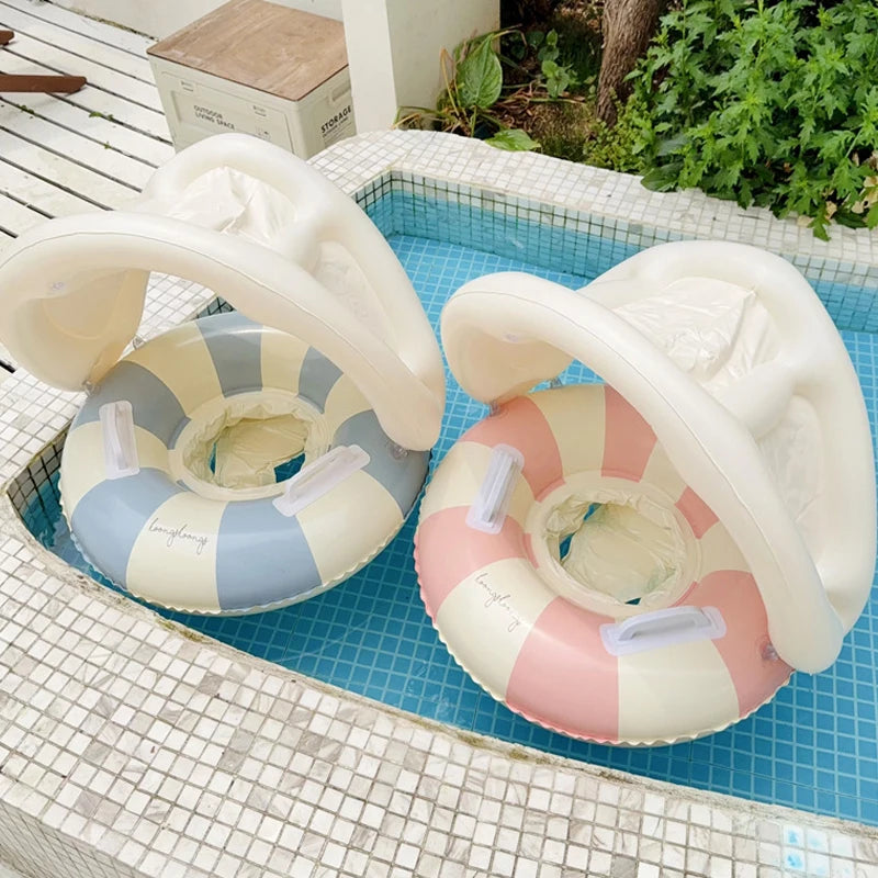 Two inflatable flamingo pool floats on a tiled pool deck.