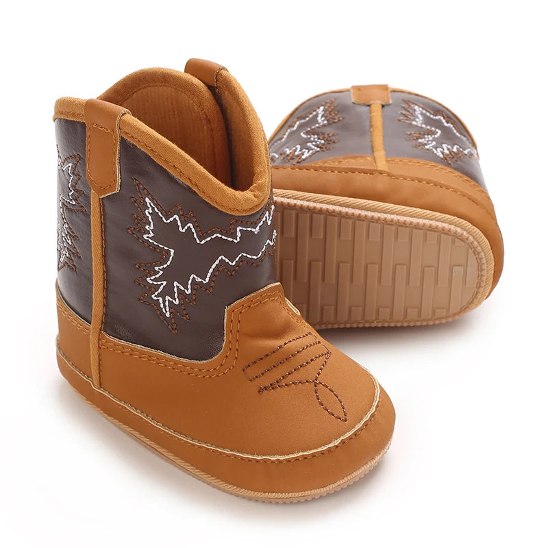 Pair of brown and gray children's cowboy boots on a white background