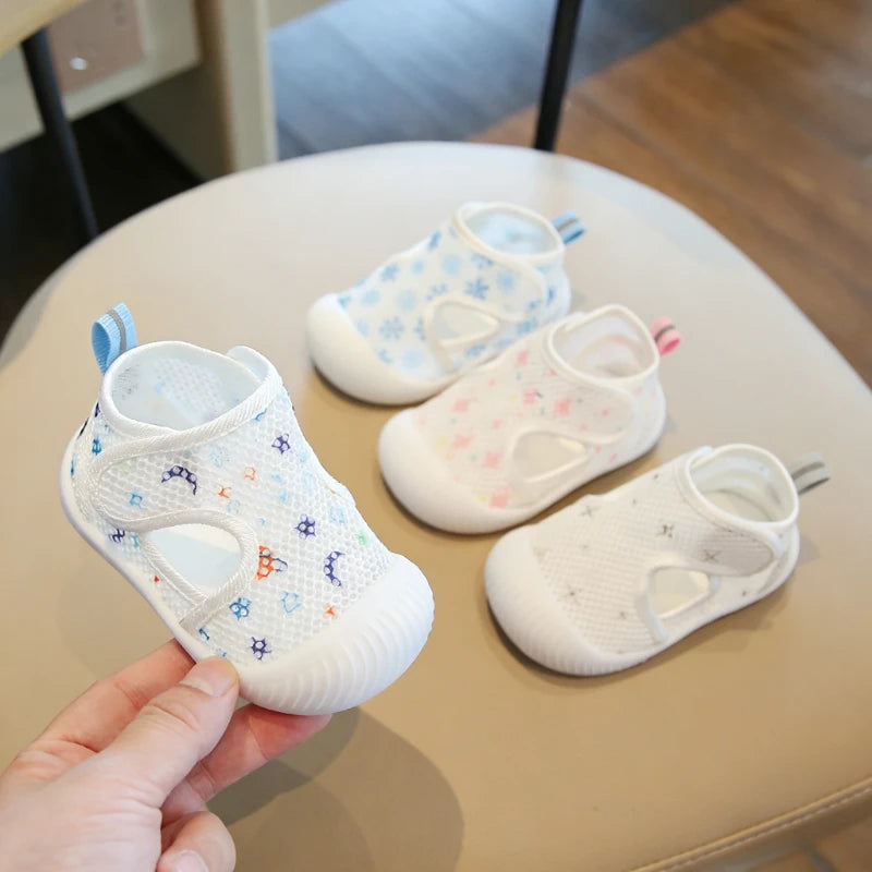 Baby shoes with colorful patterns on a beige surface