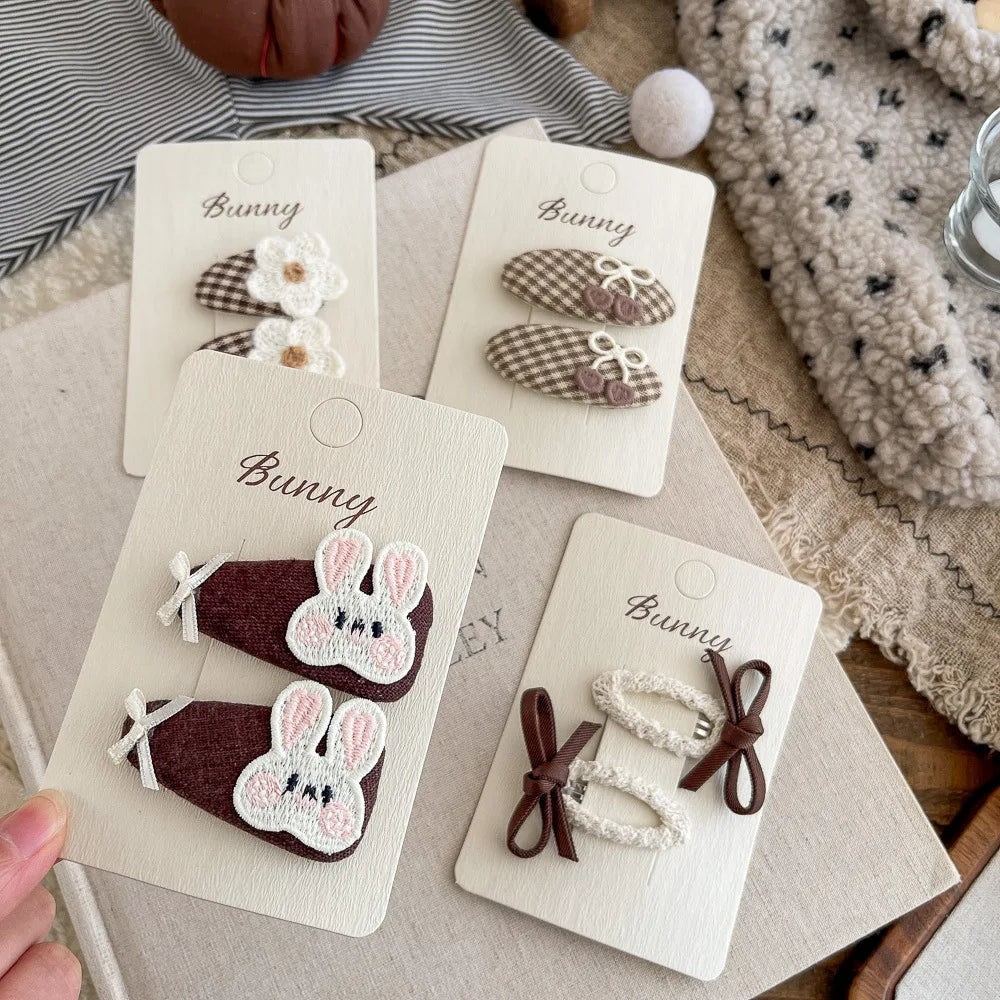 Baby girl hair clips with bunny, crochet flower, bow and checkered designs in brown and cream