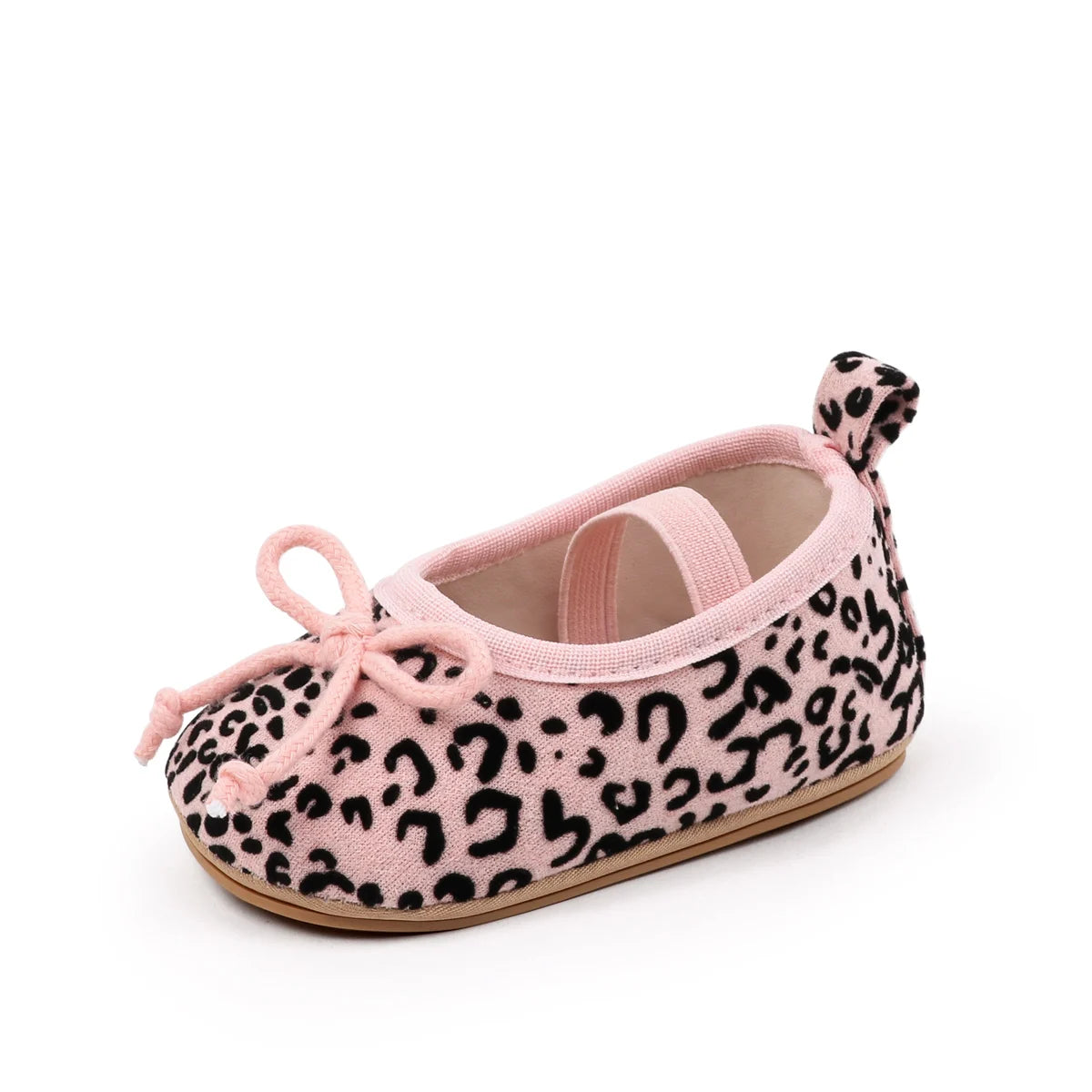 A single baby ballet flat shoe featuring a pink and black leopard print pattern, with a matching pink fabric bow on the toe and a small bow on the heel, set against a plain white background.