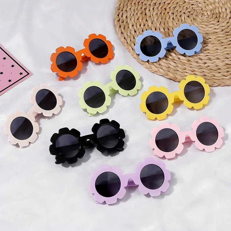 Colorful children's sunglasses with floral designs on a white background