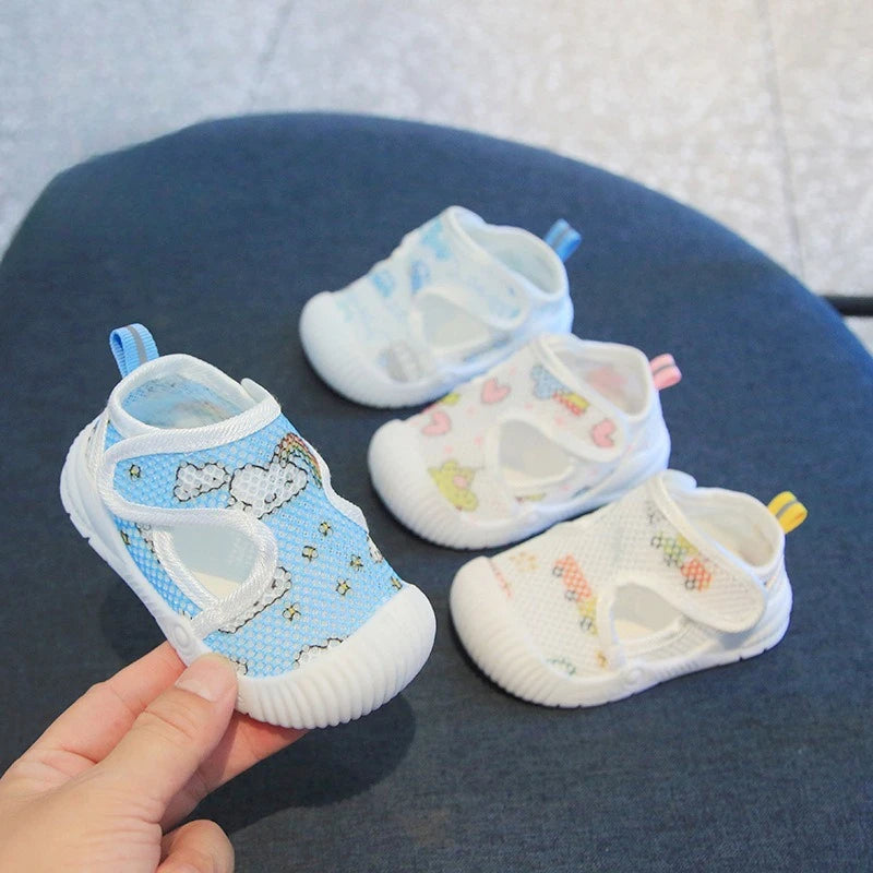 Baby shoes with colorful designs on a blue cushion