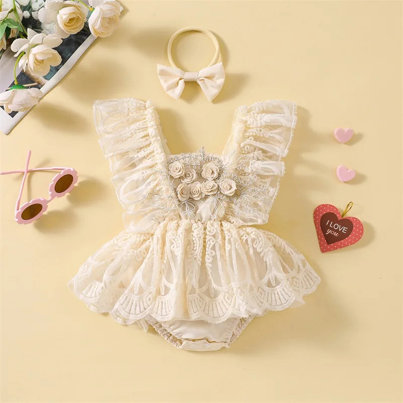 Lace baby romper with floral details on a yellow background