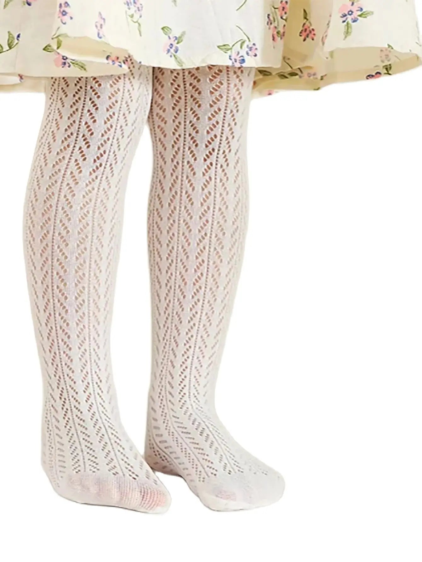 Children's patterned tights worn with a floral dress on a white background