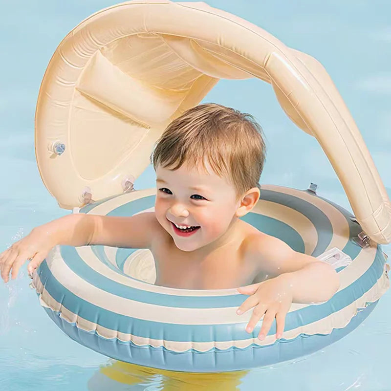 Child in a striped inflatable pool float with a canopy on a blue background